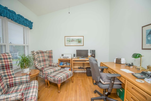 home office featuring light hardwood / wood-style floors and lofted ceiling