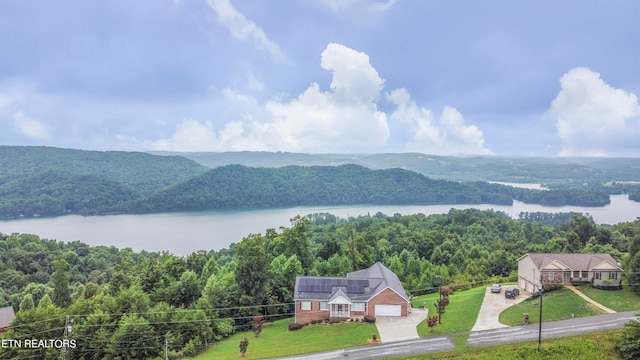 drone / aerial view with a water and mountain view