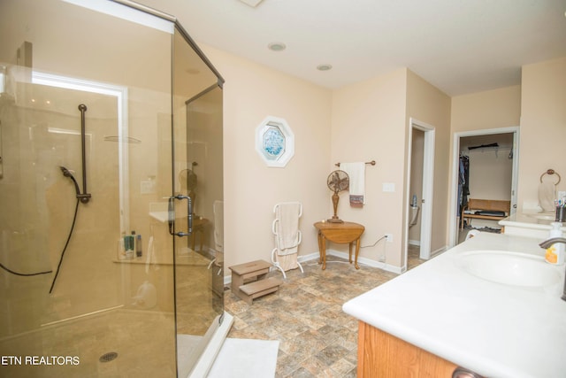 bathroom with vanity and a shower with shower door