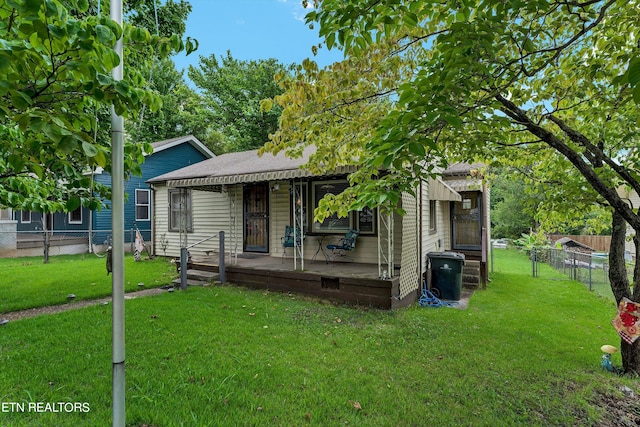 bungalow-style house with a wooden deck and a front yard