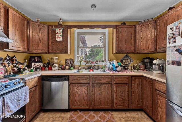 kitchen with sink, light hardwood / wood-style flooring, and stainless steel appliances