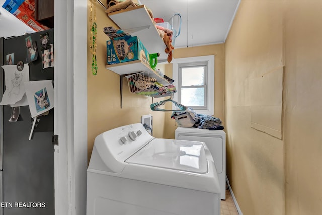 clothes washing area with separate washer and dryer