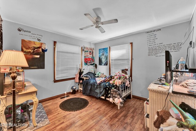 bedroom with ceiling fan and hardwood / wood-style floors