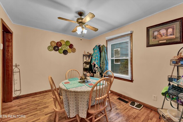 dining space featuring hardwood / wood-style flooring and ceiling fan