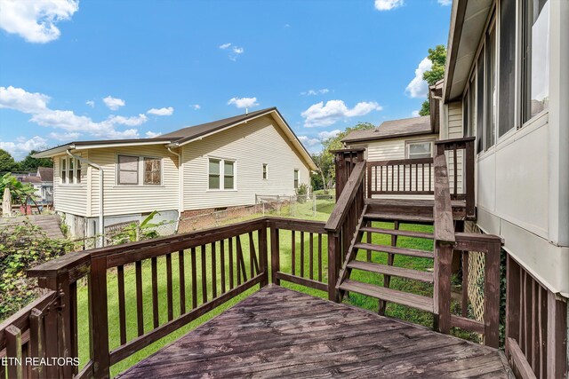 wooden deck with a lawn