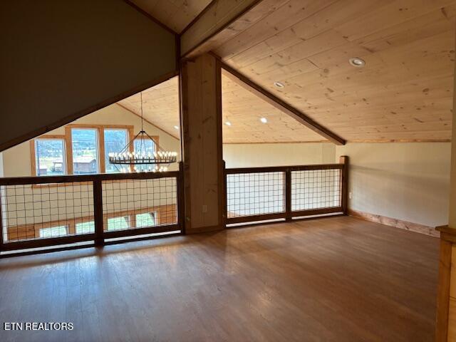 additional living space featuring hardwood / wood-style flooring, vaulted ceiling, and wood ceiling