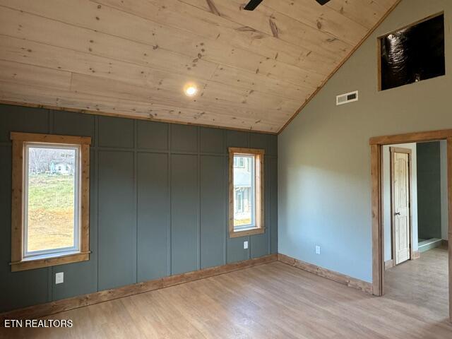 spare room with lofted ceiling, ceiling fan, wooden ceiling, and light hardwood / wood-style flooring