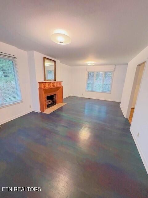 unfurnished living room featuring plenty of natural light