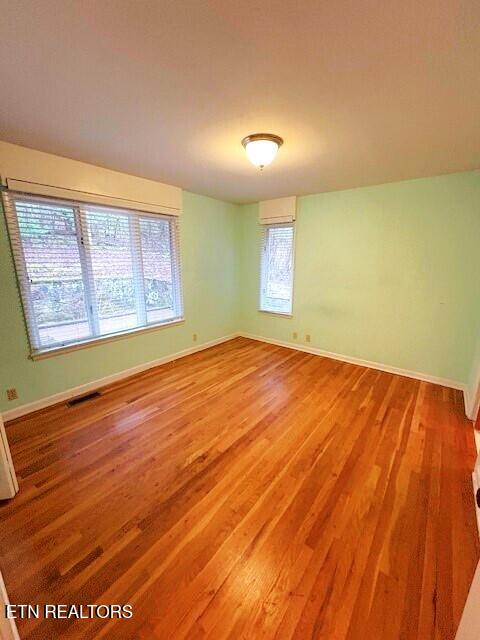 unfurnished room featuring wood-type flooring