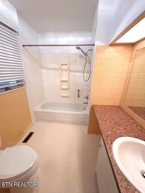 full bathroom with crown molding, shower / bathtub combination, vanity, and toilet