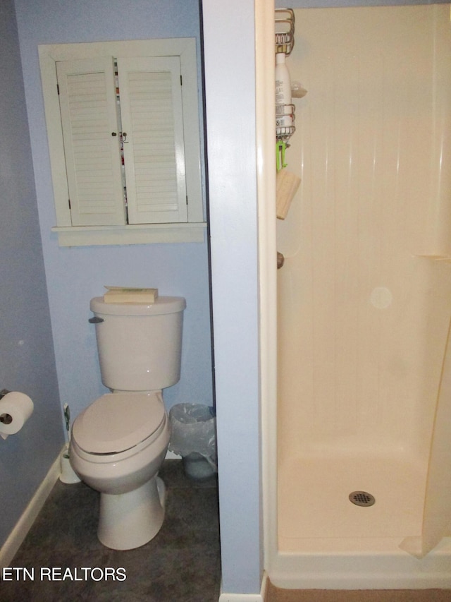 bathroom with toilet and walk in shower