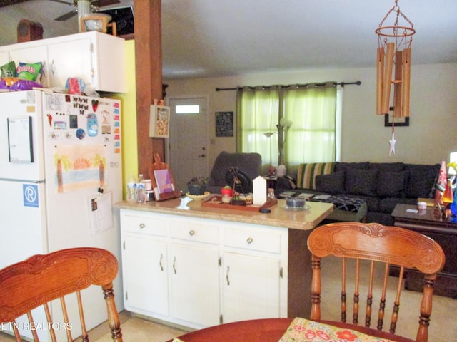 kitchen featuring white cabinetry, pendant lighting, and white fridge