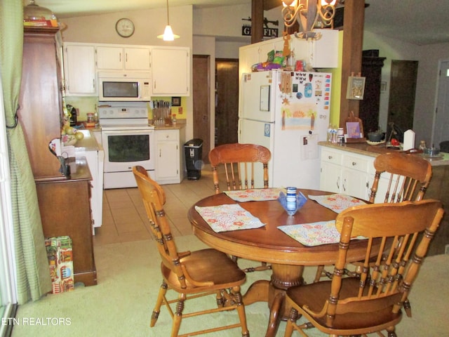 tiled dining room featuring lofted ceiling