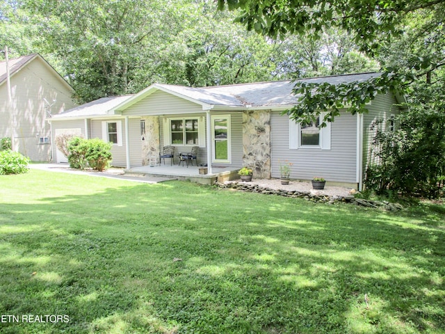 ranch-style house with a garage and a front yard