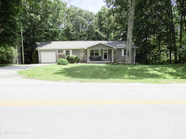 ranch-style home featuring a garage and a front lawn