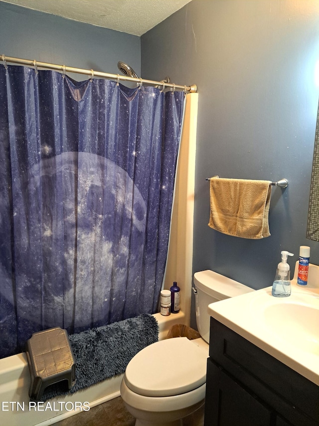 bathroom featuring vanity, a textured ceiling, and toilet