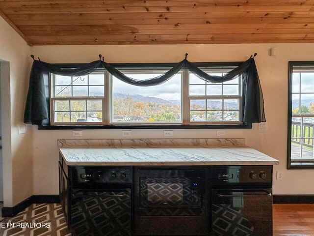 kitchen with a mountain view, wood-type flooring, and wood ceiling