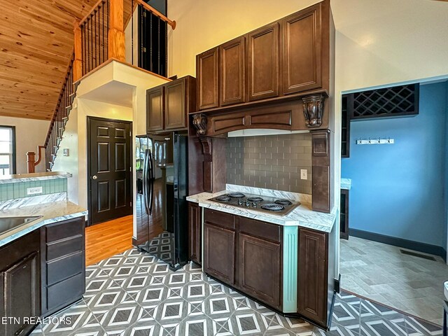 kitchen with hardwood / wood-style floors, backsplash, gas stovetop, high vaulted ceiling, and wooden ceiling