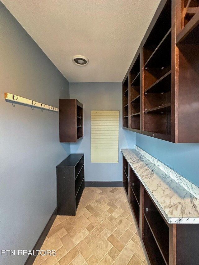 unfurnished office featuring light tile patterned flooring