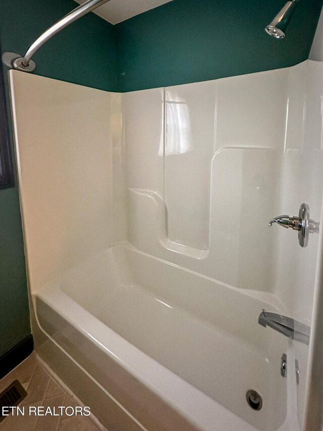 bathroom featuring bathtub / shower combination and tile patterned flooring