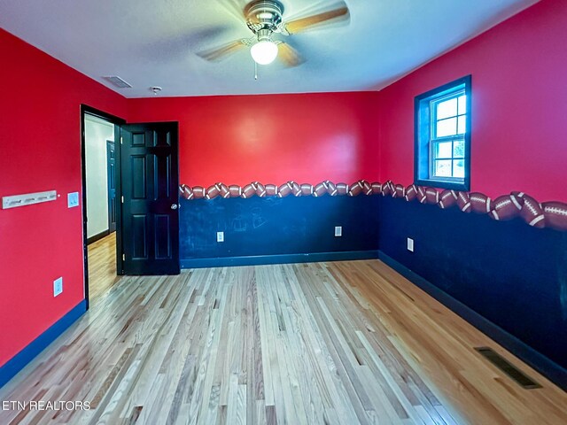 unfurnished room featuring ceiling fan and wood-type flooring