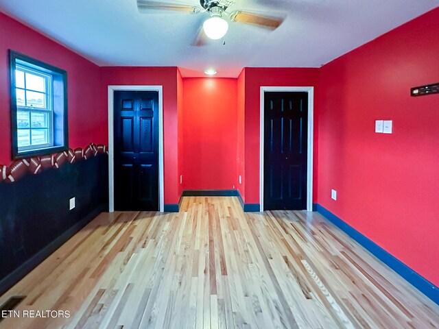 spare room featuring light hardwood / wood-style floors and ceiling fan