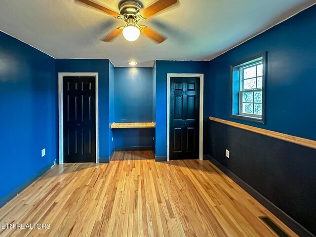 unfurnished bedroom with ceiling fan and light hardwood / wood-style floors