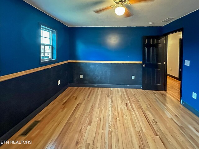 empty room featuring ceiling fan and light wood-type flooring