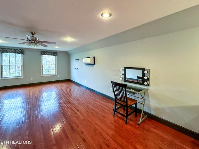 office featuring a wall mounted air conditioner, ceiling fan, and hardwood / wood-style floors