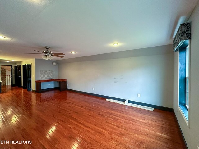 unfurnished living room featuring ceiling fan and hardwood / wood-style floors