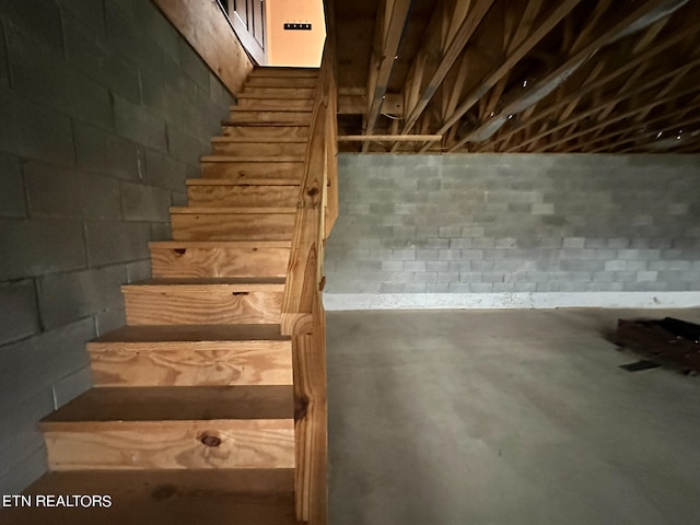 stairway featuring concrete flooring