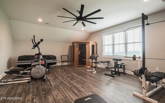 exercise area featuring visible vents, vaulted ceiling, baseboards, and wood finished floors