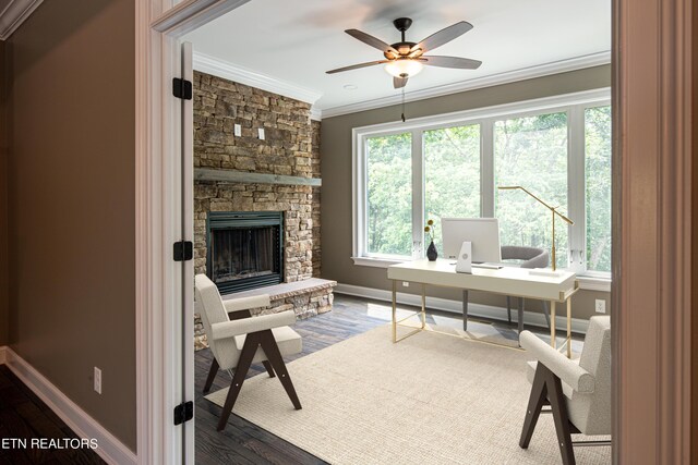 home office featuring ceiling fan, a fireplace, crown molding, and wood-type flooring