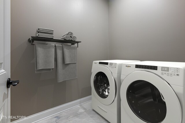 laundry area featuring light tile patterned flooring and washer and dryer