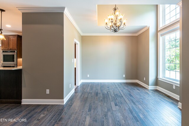 interior space featuring dark hardwood / wood-style flooring, crown molding, and plenty of natural light