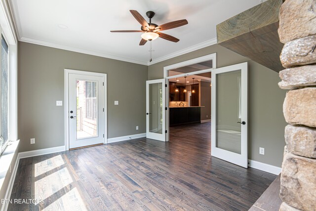 interior space with dark hardwood / wood-style flooring, french doors, ceiling fan, and ornamental molding