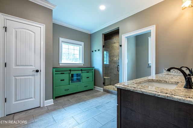 bathroom featuring vanity, an enclosed shower, tile patterned flooring, and crown molding