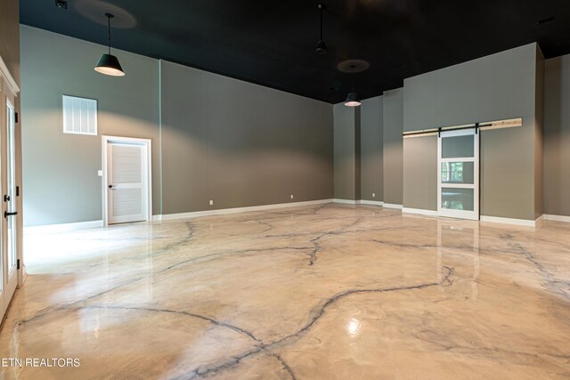 unfurnished room featuring a towering ceiling