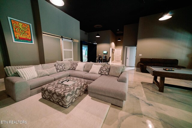 tiled cinema with pool table, a barn door, and a high ceiling