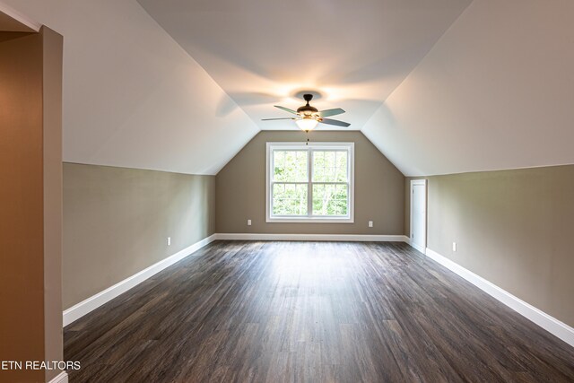 bonus room with ceiling fan, dark hardwood / wood-style flooring, and lofted ceiling