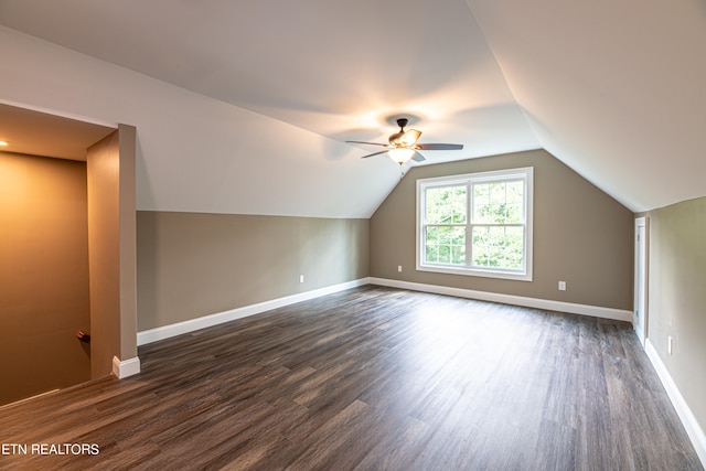 additional living space featuring vaulted ceiling, dark hardwood / wood-style flooring, and ceiling fan