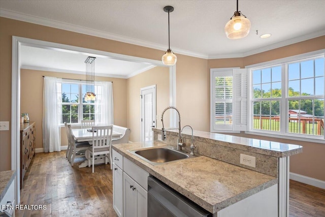 kitchen with sink, dark hardwood / wood-style flooring, plenty of natural light, and a kitchen island with sink