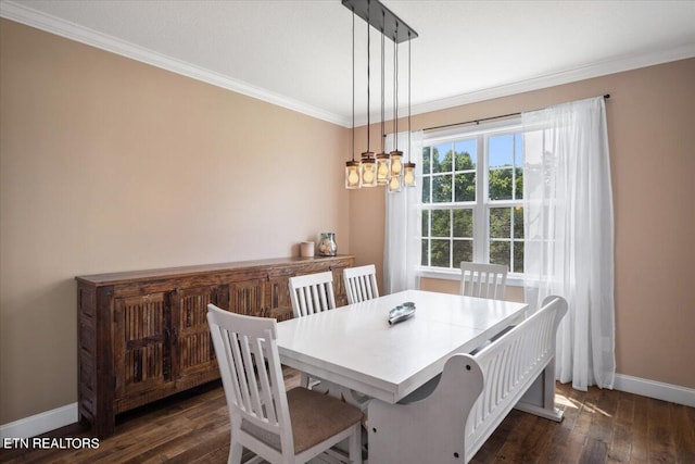 dining room featuring dark wood-type flooring, crown molding, and a chandelier