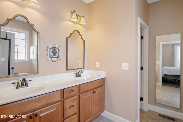 bathroom with dual vanity and tile patterned floors