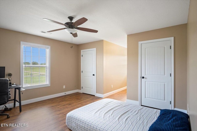 bedroom featuring hardwood / wood-style floors and ceiling fan