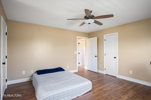 bedroom with ceiling fan and dark hardwood / wood-style floors