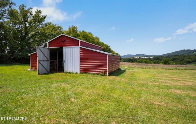 view of outbuilding with a lawn