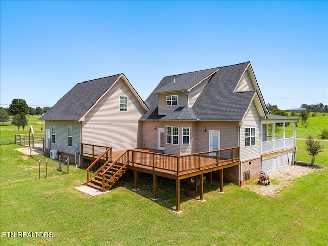 rear view of house featuring a yard and a wooden deck