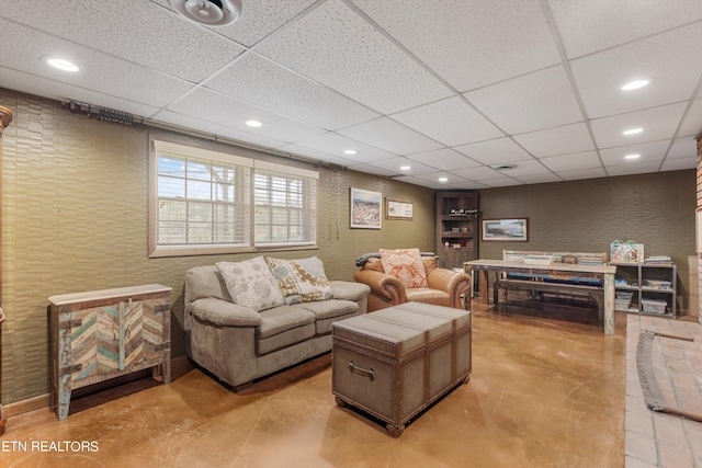 living room with light tile patterned floors and a paneled ceiling