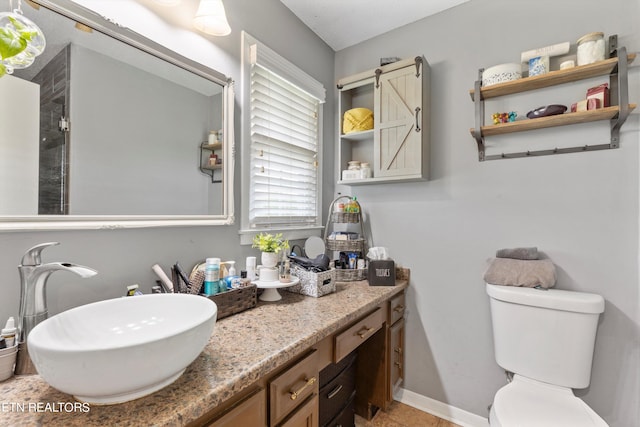 bathroom featuring tile patterned floors, toilet, and vanity